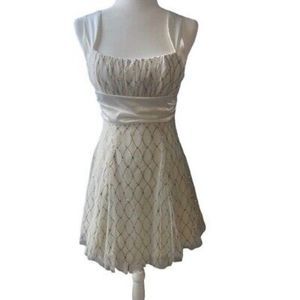 White dress with bejeweled oval pattern and silky waistline tie
